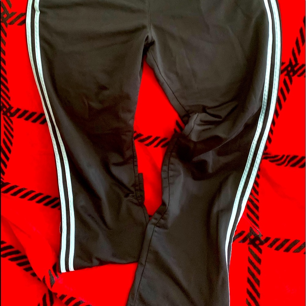 Running pants size medium with light blue stripes and slit at the ankle.